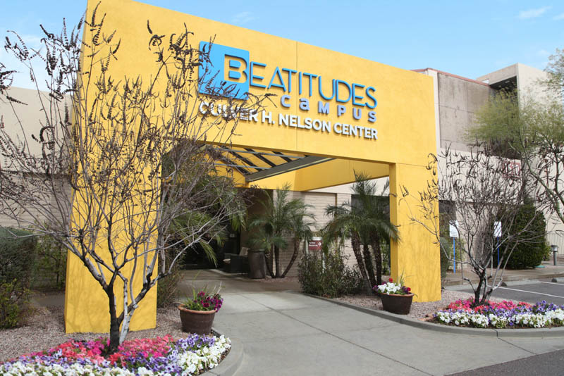 photo of the large, yellow archway to enter Beatitudes senior living campus.