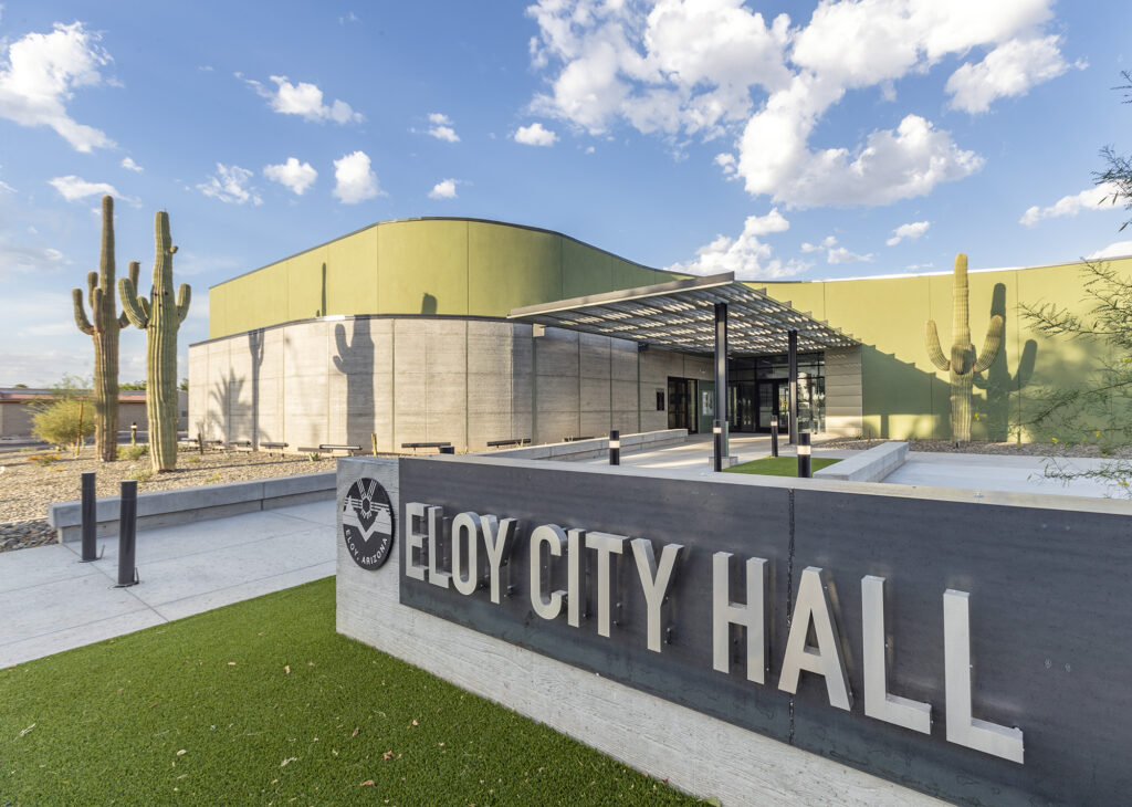 Photo of Eloy City Hall entry monument and building in the background.