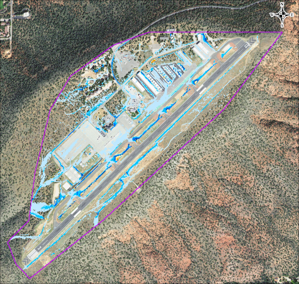 aerial image of an airport with the surrounding terrain. There are colorful markings to display the flood and drainage analysis in 2D software.