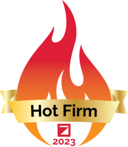 Logo of the Zweig Group's 2023 Hot Firm of the Year. It's a red flame with a yellow ribbon, scripted with "2023" on it.